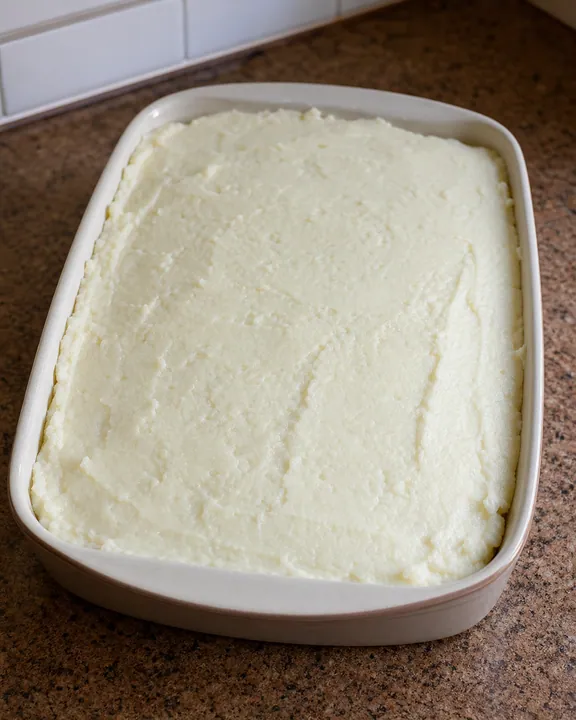 Rappie pie covered with the remaining potato mixture