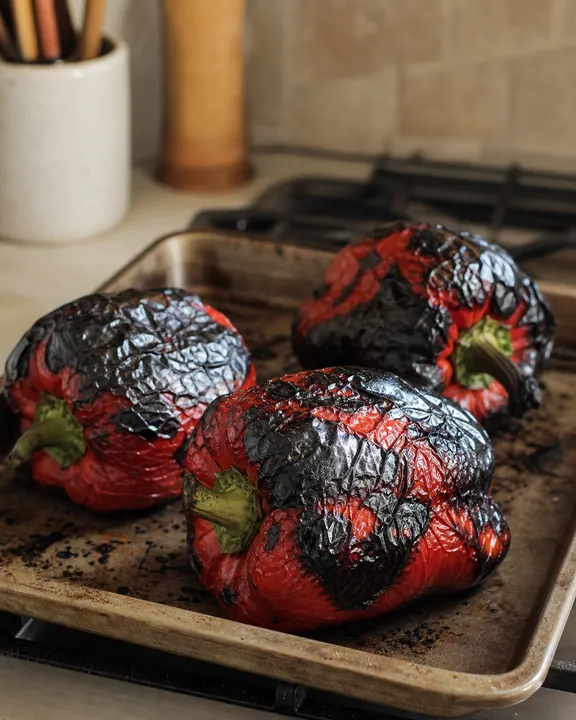 Red peppers roasting until their skins char