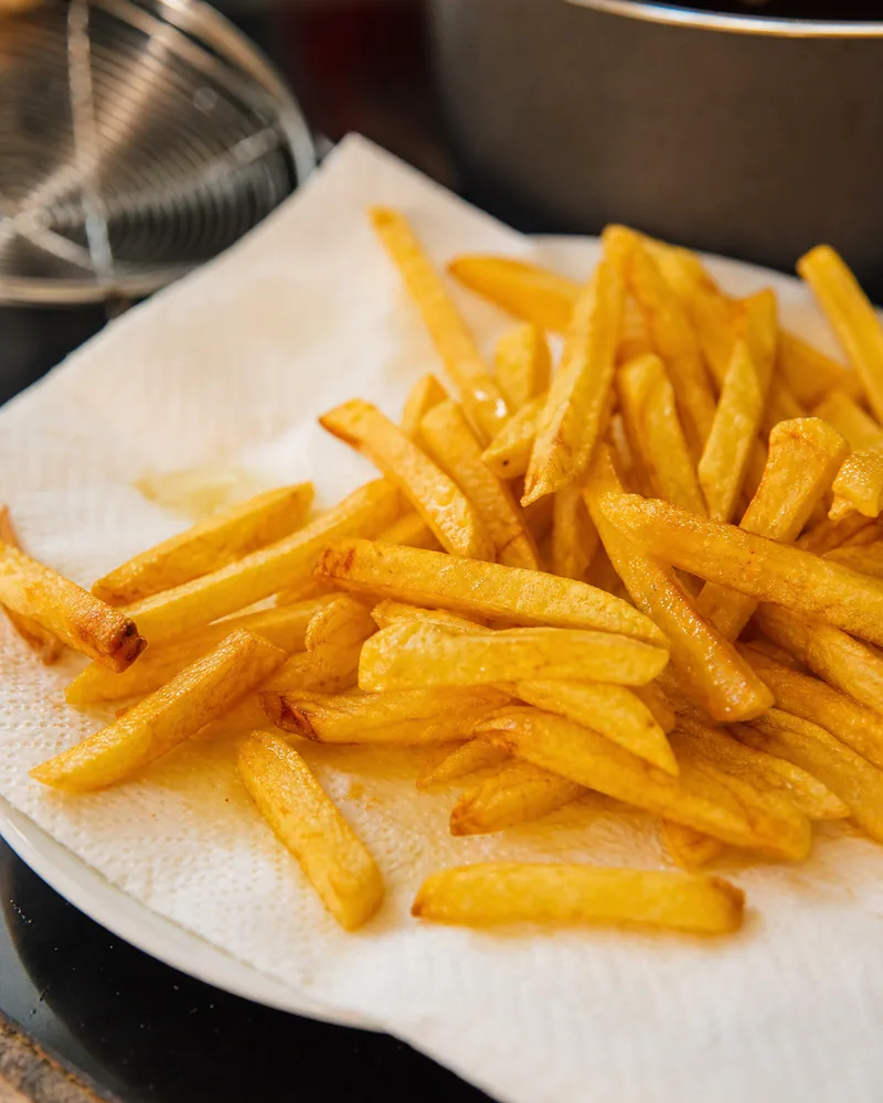French fries draining on paper towel