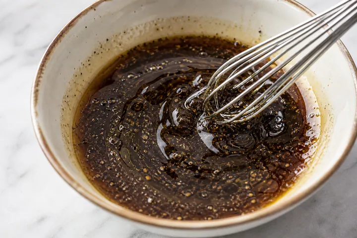 Dark pork marinade being mixed in a bowl