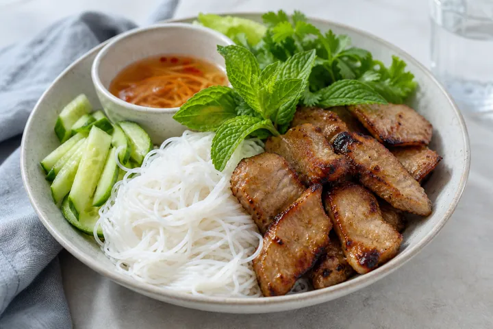 Rice vermicelli bowl with grilled pork, cucumber, and mint