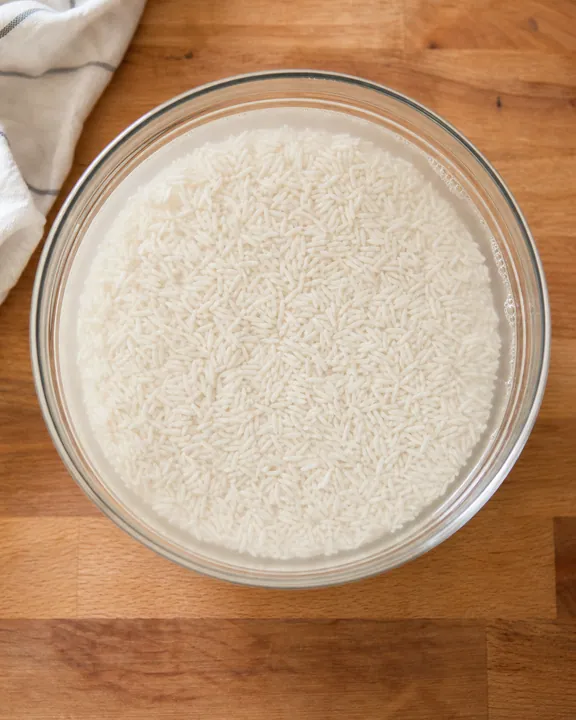 Rice soaking in water in a bowl