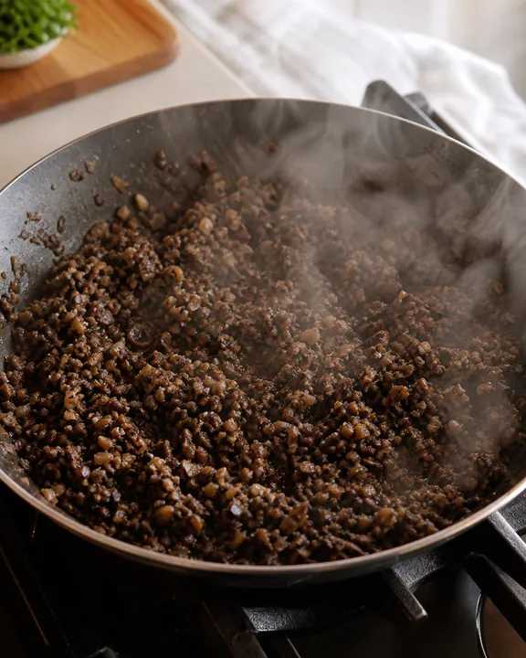 Mushroom duxelles cooking dry in skillet