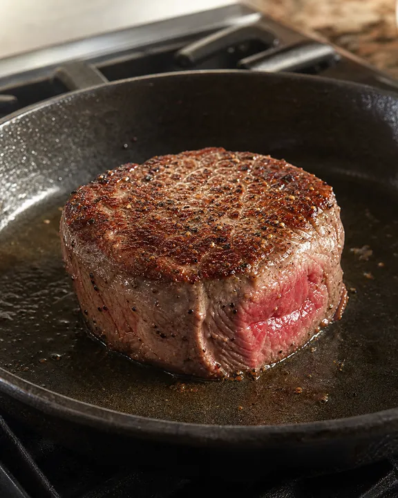 Seasoned beef fillet briefly searing for Wellington